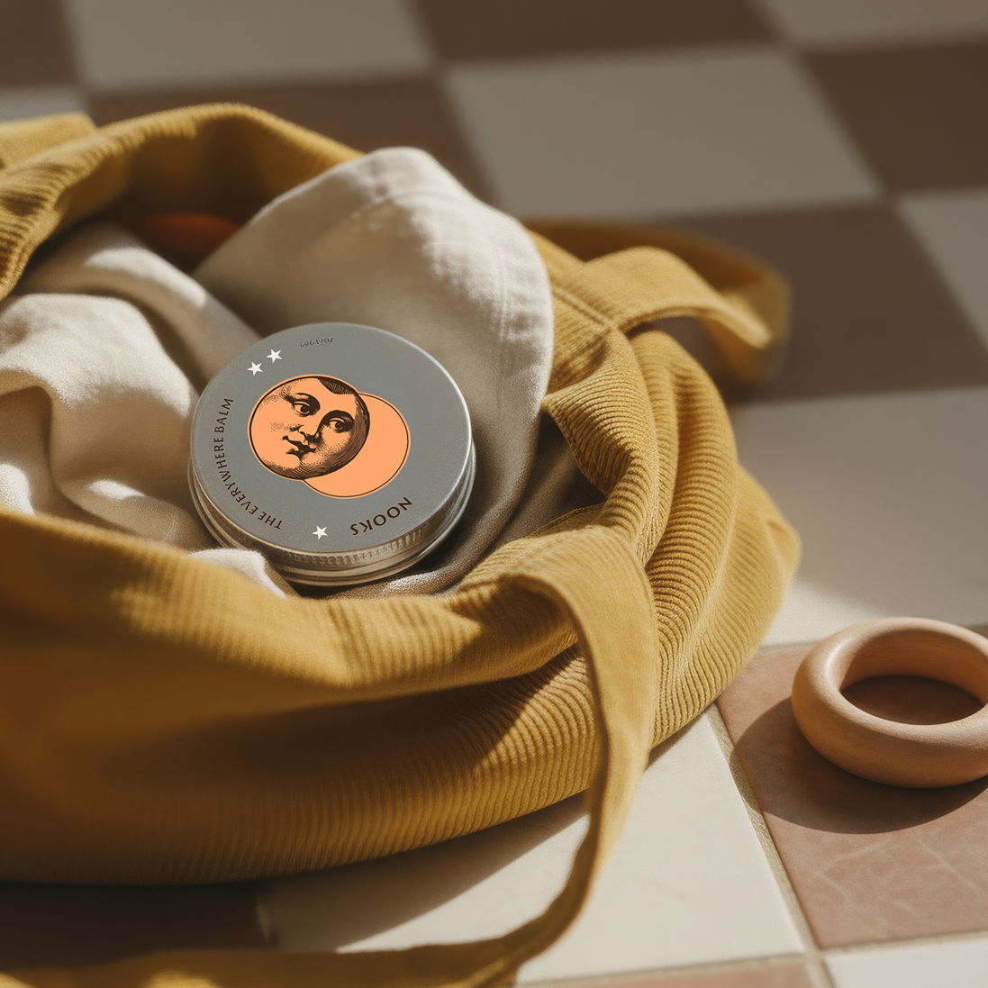 Small round container with a lid on a checkered floor